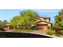 Charming two-story home with a three-car garage and lush green landscaping at 2285 Villefort Ct, Las Vegas, NV 89117