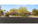 Inviting front exterior of a home with a lush lawn and three car garage at 2285 Villefort Ct, Las Vegas, NV 89117