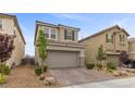 Two-story home featuring desert landscaping with a well-manicured front yard and attached two-car garage at 2293 Teatro Ave, Henderson, NV 89044