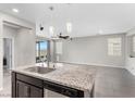 Kitchen island featuring stainless steel appliances, granite countertops, and pendant lighting at 2293 Teatro Ave, Henderson, NV 89044