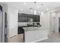 Modern kitchen with stainless steel appliances, granite countertops, pendant lights and ample cabinet space at 2293 Teatro Ave, Henderson, NV 89044