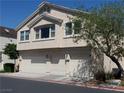 Two-story home with three-car garage and mature landscaping at street level at 4624 Snake Eyes St # 101, Las Vegas, NV 89122