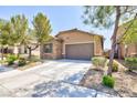 Inviting one-story home with a paved driveway, attached garage, and verdant landscaping surrounding the property at 7137 Flowering Rose Ave, Las Vegas, NV 89117