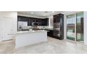 Well-equipped kitchen with stainless steel appliances, granite countertops, and functional island at 7137 Flowering Rose Ave, Las Vegas, NV 89117