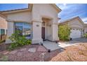 Inviting front entrance with stone accents and desert landscaping for a charming curb appeal at 90 Ancient Hills Ln, Henderson, NV 89074