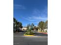 Community entrance featuring meticulously landscaped median and gated access for residents at 1205 Padre Serra Ln, Las Vegas, NV 89134