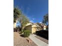 Lovely two-story home featuring desert landscaping, a two car garage, and a sunny blue sky at 1205 Padre Serra Ln, Las Vegas, NV 89134