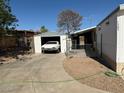 View of the home's driveway and detached garage, showing the side entry to the home and partial landscaping at 1305 Shenandoah St, Boulder City, NV 89005