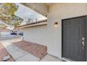 Inviting home entrance with a dark-colored front door, desert landscaping and a tile roof adding warmth at 1472 Recital Way, Las Vegas, NV 89119