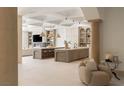 Bright and airy living area featuring high ceilings, tile floors, neutral tones, and access to kitchen at 15 Vintage Canyon St, Las Vegas, NV 89141