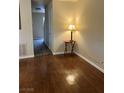 Inviting living room with rich hardwood floors and views of the hallway at 158 Greenbriar Townhouse Way, Las Vegas, NV 89121