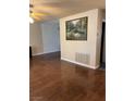 Spacious living room with hardwood floors, ceiling fan, painting and air vent at 158 Greenbriar Townhouse Way, Las Vegas, NV 89121