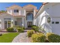 Attractive two-story home with beautiful front garden and brick walkway at 1613 Iron Ridge Dr, Las Vegas, NV 89117