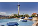 Rooftop pool area with lounge chairs and views of the Stratosphere Tower at 200 W Sahara Ave # 2407, Las Vegas, NV 89102