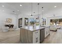 Open kitchen with a large island, modern appliances, and access to the backyard at 2317 Sierra Heights Dr, Las Vegas, NV 89134