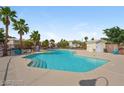 Enjoy this inviting community pool surrounded by mature trees and comfortable lounge chairs at 2509 April Breeze Ln, Henderson, NV 89002