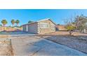 This is a single-story home showing the driveway and low maintenance yard at 2708 Bello Dr, North Las Vegas, NV 89030