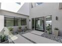 Modern home featuring a courtyard entrance with desert landscaping, clean lines, and ample natural light at 29 Falling Ridge Ln, Henderson, NV 89011