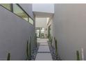 Modern home entryway featuring stone pavers, desert landscaping, and a sleek, minimalist design at 29 Falling Ridge Ln, Henderson, NV 89011