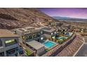 Beautiful modern homes sit hillside with pools and views of the city lights in the distance at 302 Watteau Ct, Henderson, NV 89012