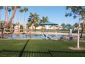 Lake view with lounge chairs and umbrellas on the grassy area of the Lake Las Vegas community at 3151 Soaring Gulls Dr # 2035, Las Vegas, NV 89128