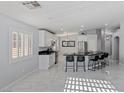 Bright, updated kitchen with stainless steel appliances, modern island, and sleek countertops at 3197 Castle Canyon Ave, Henderson, NV 89052