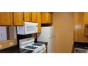 Bright kitchen with appliances, black countertops, and ample cabinet space at 3318 N Decatur Blvd # 1002, Las Vegas, NV 89130