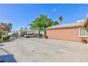 Wide driveway and mature trees on the side of the home at 3814 Connie Ave, Las Vegas, NV 89115