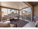 Relaxing sun room with comfortable seating, a ceiling fan, and sliding glass windows overlooking the backyard at 4368 Latitude Valley Ct, North Las Vegas, NV 89084