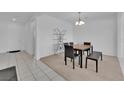 Cozy dining area with modern lighting fixture and neutral color scheme at 45 Via Di Mello, Henderson, NV 89011