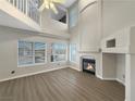 Bright living room with a fireplace, high ceilings and large windows that let in plenty of natural light at 504 Landra Ln, Henderson, NV 89015