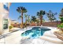 Backyard pool featuring desert landscaping, palm trees, and a concrete patio at 5737 Heather Breeze Ct, Las Vegas, NV 89141