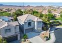 Charming two-story home featuring a tile roof, balcony, and a well-manicured front yard in a tranquil neighborhood at 580 Via Di Parione Ct, Henderson, NV 89011