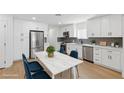 Bright kitchen features stainless steel appliances, gray backsplash, and modern white cabinetry at 613 Kings Pl, Boulder City, NV 89005