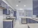 Modern kitchen featuring stainless steel appliances, granite countertops, and ample cabinet space at 6709 Barrington Hills St, Las Vegas, NV 89149