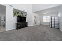 Spacious living room with new gray carpet, light walls, and plenty of natural light at 6973 Pacific Coast St, Las Vegas, NV 89148