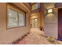 Inviting home entrance with a brick path and a stylish front door with modern hardware at 7 Hilltop Crest St, Henderson, NV 89011