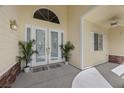 Welcoming covered entrance showcasing double doors, neutral colors, and decorative plants at 7460 Grassy Field Ct, Las Vegas, NV 89131