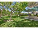 Lush green park offers a serene escape with picnic tables and well-maintained tennis courts at 7460 Grassy Field Ct, Las Vegas, NV 89131