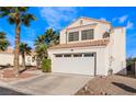 Two-story home featuring a well-manicured front yard and a two-car garage at 7912 Painted Rock Ln, Las Vegas, NV 89149