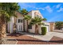Elegant home showcasing lush landscaping, a driveway, and architectural design at 7912 Painted Rock Ln, Las Vegas, NV 89149