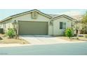 Inviting single-story home with a two-car garage and low maintenance desert landscaping at 8223 Buffalo Ranch Ave, Las Vegas, NV 89147