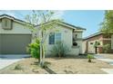 Lovely single-story home with desert landscaping, a two-car garage and a secure gate at 8223 Buffalo Ranch Ave, Las Vegas, NV 89147