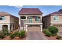 Lovely two-story home with a front-facing balcony and well-manicured landscaping, featuring a stylish brick driveway at 8276 Sorrel St, Las Vegas, NV 89139
