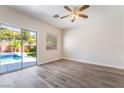 The bedroom offers natural light with backyard views, tile floors and sliding door access at 844 Binbrook Dr, Henderson, NV 89052