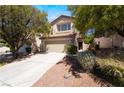 Charming two-story home featuring a well-maintained front yard and an attached two-car garage at 844 Binbrook Dr, Henderson, NV 89052
