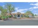 Charming single-story house featuring mature trees and a well-maintained lawn at 8945 S Tenaya Way, Las Vegas, NV 89113