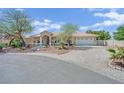 Beautiful home with a tile roof, attached garage, and meticulously landscaped front yard at 8945 S Tenaya Way, Las Vegas, NV 89113