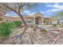 Attractive home with a covered front porch and a stone accented front yard at 8945 S Tenaya Way, Las Vegas, NV 89113