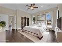 Spacious main bedroom boasts dark wood floors, walk-in closet, and plenty of natural light at 8945 S Tenaya Way, Las Vegas, NV 89113